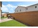 Private backyard with artificial grass, brick wall, and a built-in BBQ area with grill at 3641 Portici Ln, Henderson, NV 89044