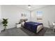 Comfortable bedroom with large window and neutral color palette, and modern decor at 3641 Portici Ln, Henderson, NV 89044