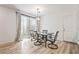 Open dining area features sliding glass doors, wood floors, modern light fixtures, and neutral walls at 3641 Portici Ln, Henderson, NV 89044