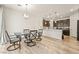 Open dining area connected to kitchen featuring wood floors, modern light fixtures, and neutral walls at 3641 Portici Ln, Henderson, NV 89044