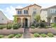 Charming two-story home with a landscaped front yard, black fence, and stairs leading to an arched doorway at 3641 Portici Ln, Henderson, NV 89044