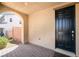 Inviting front porch with brick flooring and a dark-colored front door with an arched entryway at 3641 Portici Ln, Henderson, NV 89044