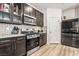 Modern kitchen with dark wood cabinets, white countertops, stainless steel appliances, and wood flooring at 3641 Portici Ln, Henderson, NV 89044