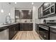 Modern kitchen featuring dark wood cabinets, white countertops, stainless steel appliances, and stylish backsplash at 3641 Portici Ln, Henderson, NV 89044