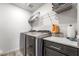 This laundry room has modern washer and dryer with plenty of counter space and storage at 3641 Portici Ln, Henderson, NV 89044