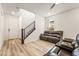 Cozy living area with wood-look floors, staircase, and comfortable leather seating at 3641 Portici Ln, Henderson, NV 89044