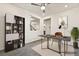 Bright home office boasts built-in shelving, modern desk, decor, and neutral paint at 3641 Portici Ln, Henderson, NV 89044
