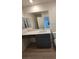 Bathroom with a vanity featuring a sink, mirror, storage cabinet, and modern fixtures at 3654 Stoppani Ave, Henderson, NV 89044