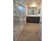 Well-lit bathroom with double sinks, tile flooring, and a glass-enclosed shower for a spa-like experience at 3654 Stoppani Ave, Henderson, NV 89044