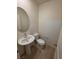 Clean and modern half bathroom with pedestal sink and tile flooring, perfect for guests at 3654 Stoppani Ave, Henderson, NV 89044