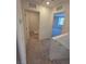 Hallway with neutral carpet leading to closets and bedrooms, offering a seamless transition between spaces at 3654 Stoppani Ave, Henderson, NV 89044