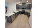 Modern kitchen boasts stainless steel appliances, gray cabinets, and a large island with stone countertops at 3654 Stoppani Ave, Henderson, NV 89044