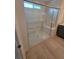 Bright bathroom with a modern walk-in shower featuring glass doors and a built-in seat at 3654 Stoppani Ave, Henderson, NV 89044