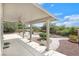 Wonderful backyard featuring a covered patio with ceiling fan and winding brick pathways amongst desert landscaping at 3689 Bufflehead St, Las Vegas, NV 89122