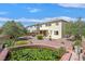 Large backyard featuring a tranquil water feature, landscaping, and a view of the home's exterior at 3689 Bufflehead St, Las Vegas, NV 89122
