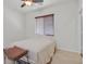 Simply furnished bedroom with neutral walls, tile floors, a ceiling fan, and a closed window at 3689 Bufflehead St, Las Vegas, NV 89122