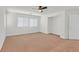 Bright bedroom featuring two windows and neutral carpeting at 3689 Bufflehead St, Las Vegas, NV 89122