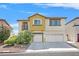 Inviting two-story home featuring a two-car garage, desert landscaping, and sunny curb appeal at 3689 Bufflehead St, Las Vegas, NV 89122