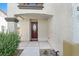 Close-up of the front door featuring a decorative glass insert, with drought-tolerant landscaping at 3689 Bufflehead St, Las Vegas, NV 89122