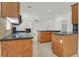 Open kitchen with wood cabinets, granite counters, and stainless steel appliances at 3689 Bufflehead St, Las Vegas, NV 89122