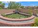 Relaxing backyard featuring a brick-lined pond with a gentle waterfall and blooming water lilies at 3689 Bufflehead St, Las Vegas, NV 89122