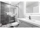 Updated bathroom features a glass shower, vanity with sink and modern lighting at 3825 Manhattan Bridge Pl, North Las Vegas, NV 89032