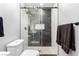 Modern bathroom with frameless shower, pebble floor, and black fixtures at 3825 Manhattan Bridge Pl, North Las Vegas, NV 89032