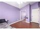 Bedroom in lavender features a mirrored closet, dark wood floors and white trim at 3825 Manhattan Bridge Pl, North Las Vegas, NV 89032