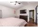 Bedroom features include a ceiling fan, TV, dresser, and ensuite bathroom at 3825 Manhattan Bridge Pl, North Las Vegas, NV 89032