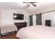 Bedroom features include a ceiling fan, TV, dresser, and barn door access to bathroom at 3825 Manhattan Bridge Pl, North Las Vegas, NV 89032