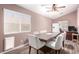 Dining room features a large wood table with six cushioned chairs under a ceiling fan at 3825 Manhattan Bridge Pl, North Las Vegas, NV 89032