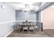 Dining room features a gray table with chairs, a modern ceiling fan, and blue walls at 3825 Manhattan Bridge Pl, North Las Vegas, NV 89032