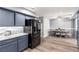 Modern kitchen with gray cabinets, stainless steel appliances, and a dining room attached at 3825 Manhattan Bridge Pl, North Las Vegas, NV 89032