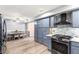 Connected kitchen and dining area with stainless steel appliances and light blue cabinets at 3825 Manhattan Bridge Pl, North Las Vegas, NV 89032