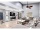 Open-concept living room featuring gray laminate flooring, high ceilings, and stone-accented TV wall at 3825 Manhattan Bridge Pl, North Las Vegas, NV 89032