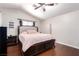 Cozy bedroom with a tufted headboard, a ceiling fan, and plush pink bedding at 3825 Manhattan Bridge Pl, North Las Vegas, NV 89032