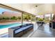 Spacious covered patio with ample seating, pool view, and billiard table at 3825 Manhattan Bridge Pl, North Las Vegas, NV 89032