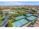 Aerial view of community with tennis courts, swimming pool, and well-maintained landscaping at 389 Fringe Ruff Dr, Las Vegas, NV 89148