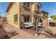 Backyard with seating area under a pergola and a dining table with chairs at 389 Fringe Ruff Dr, Las Vegas, NV 89148