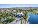 Aerial view of a community entrance with well-manicured landscaping and a serene lake at 389 Fringe Ruff Dr, Las Vegas, NV 89148