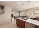 A kitchen with stainless steel appliances, a white countertop, and a view of the living room at 389 Fringe Ruff Dr, Las Vegas, NV 89148