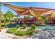 Community playground with slides, climbing structures, and sunshades, perfect for families at 389 Fringe Ruff Dr, Las Vegas, NV 89148