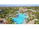 A captivating aerial shot of a resort-style pool area with clear blue water, lush landscaping, and ample seating at 389 Fringe Ruff Dr, Las Vegas, NV 89148