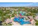 A scenic aerial view of a resort waterpark featuring colorful slides, pool, and palm trees, perfect for Gathering fun at 389 Fringe Ruff Dr, Las Vegas, NV 89148