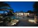 Evening shot of a spacious backyard, featuring a sparkling pool and well-lit patio area perfect for entertaining at 4343 Sharpshooter Ln, North Las Vegas, NV 89031