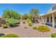 Landscaped backyard with a covered patio and colorful plants at 4369 Meadowlark Wing Way, North Las Vegas, NV 89084