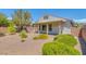 Backyard with covered patio and landscaped area with colorful plants at 4369 Meadowlark Wing Way, North Las Vegas, NV 89084