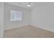 Clean, carpeted bedroom with a ceiling fan and window at 4369 Meadowlark Wing Way, North Las Vegas, NV 89084