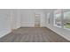 Bright bedroom with gray carpet and large window, leading to an ensuite bathroom at 4369 Meadowlark Wing Way, North Las Vegas, NV 89084