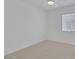 Bedroom with neutral carpet, bright window, and fresh white paint at 4369 Meadowlark Wing Way, North Las Vegas, NV 89084